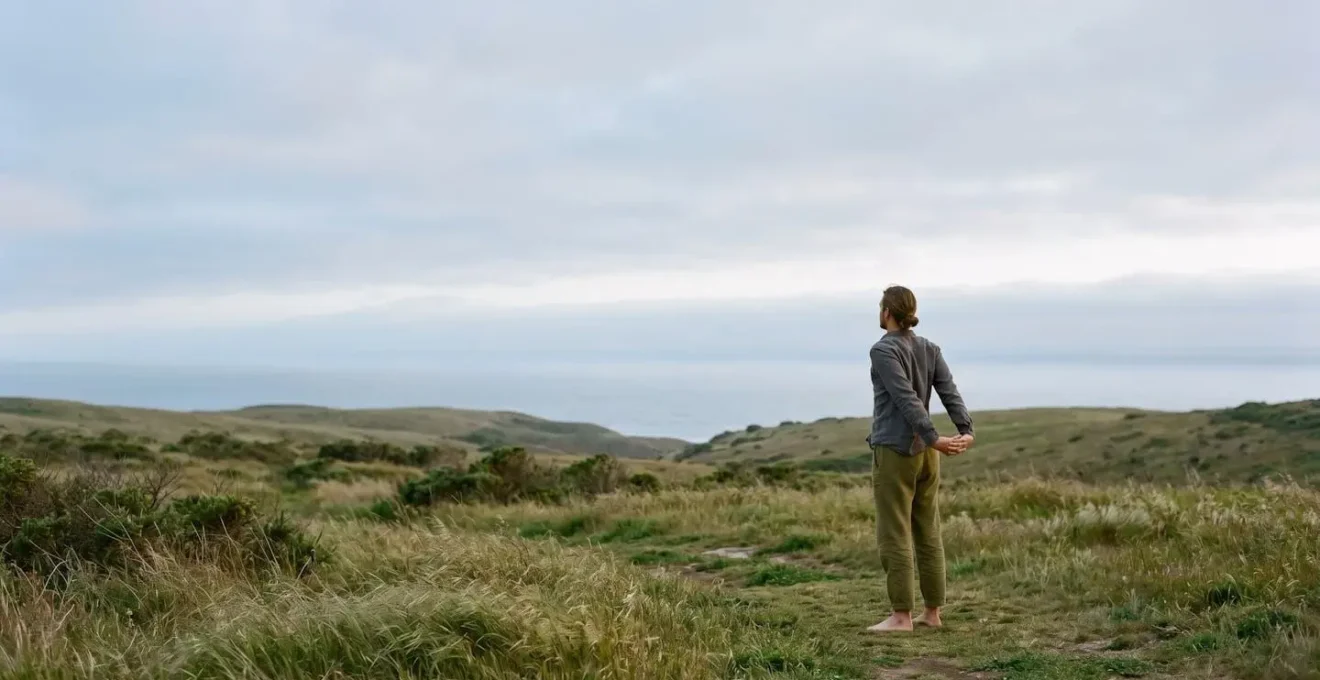 Person engaged in gentle, restorative movement in a peaceful natural environment