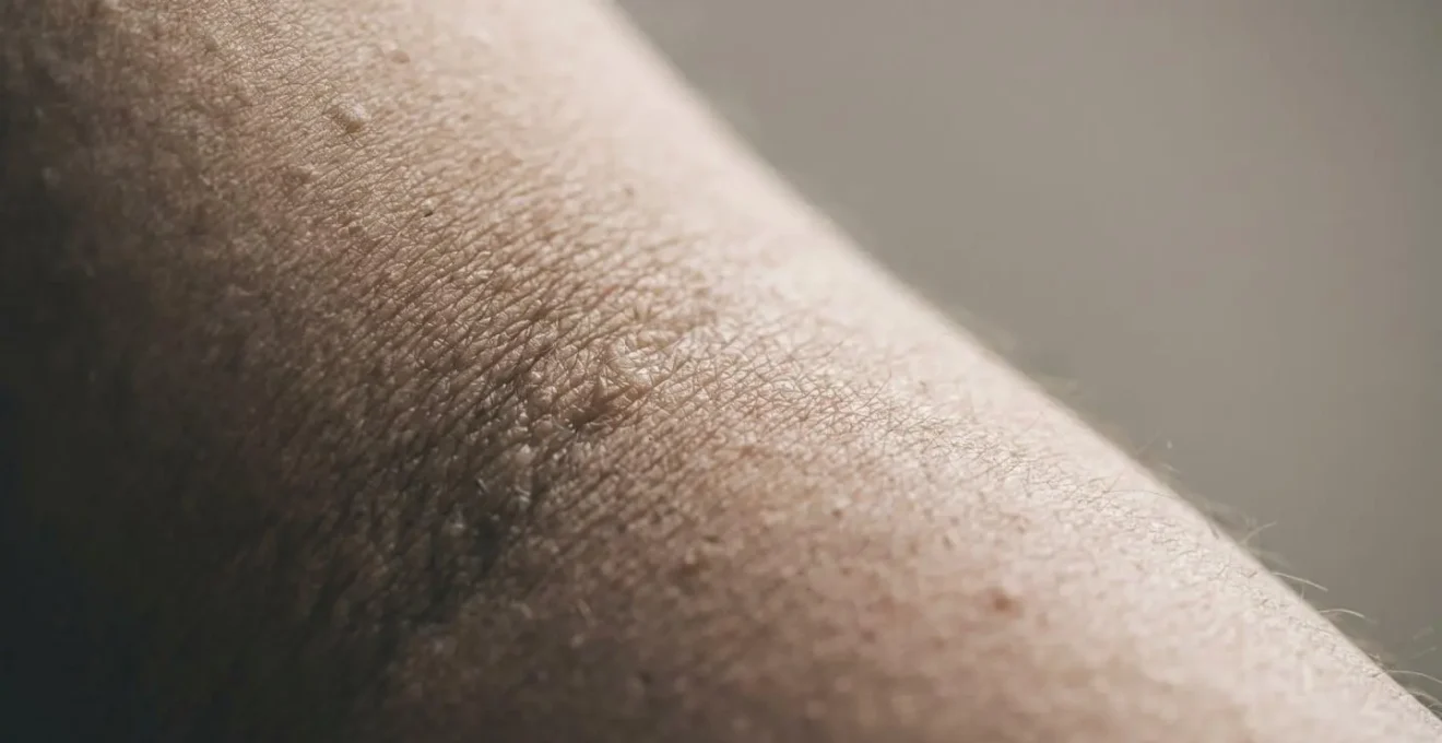 Close-up of continuous glucose monitoring sensor on upper arm demonstrating home testing capability