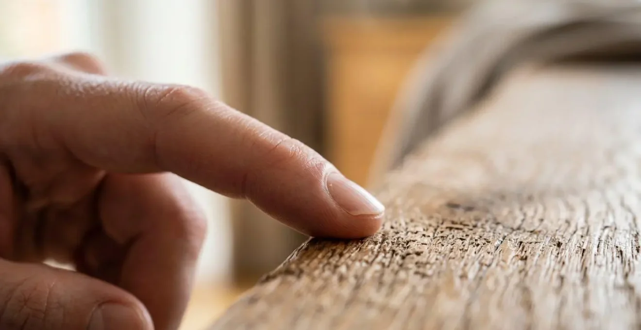 Macro close-up of hands in mindful transition gesture with natural textures and shallow depth of field